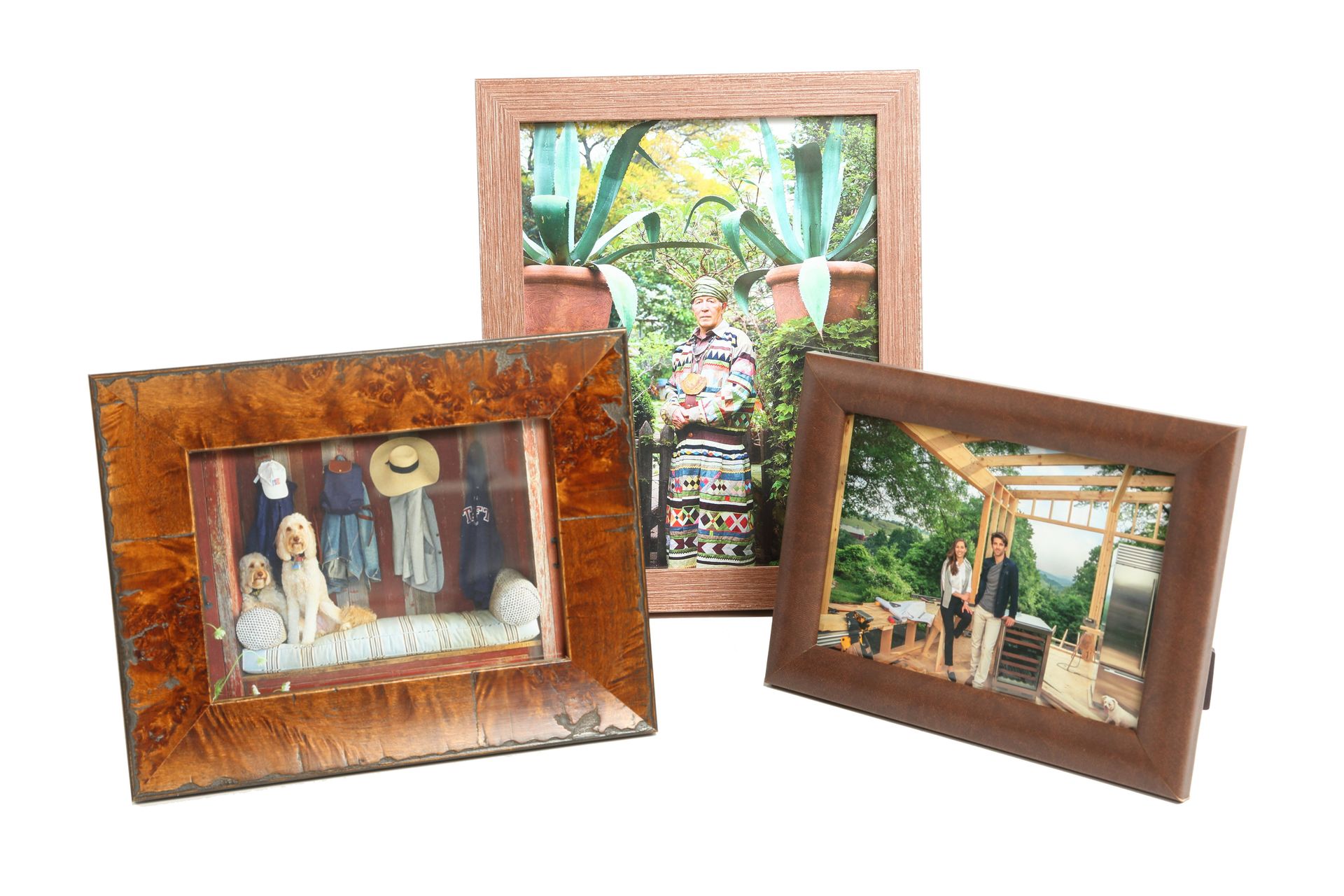 Three tabletop frames in copper, burl wood, and leather finishes, each holding a different photograph